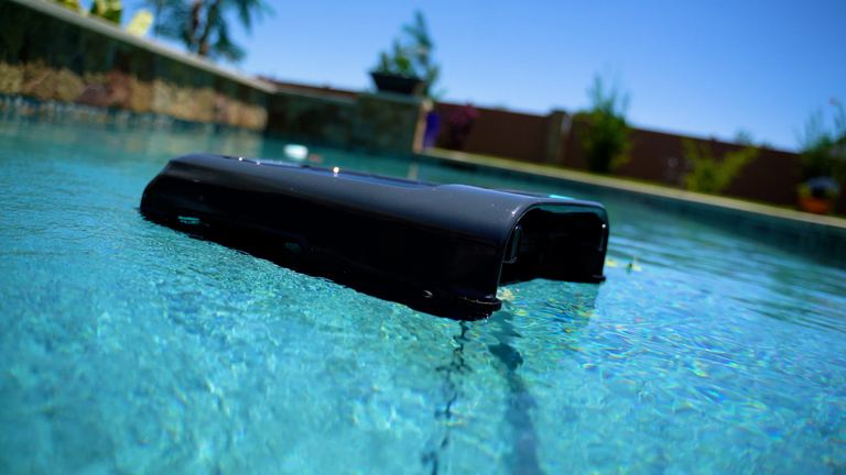 Aiper Surfer S2 Gliding Across Pool Low Rear Angle