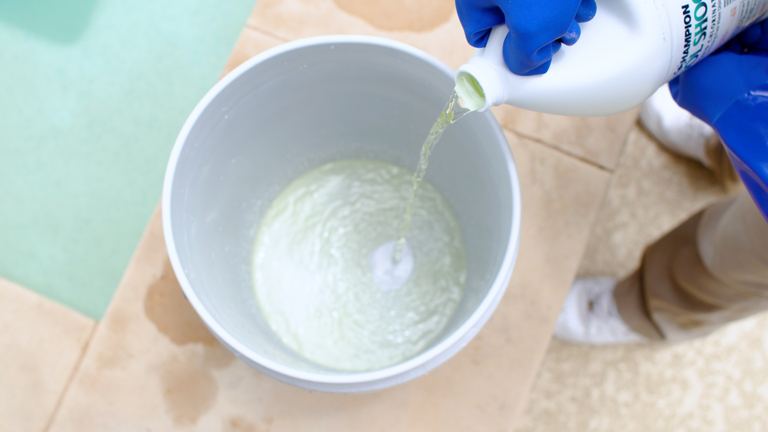 Champion Pool Shock Pouring Stream Into Bucket Overhead View