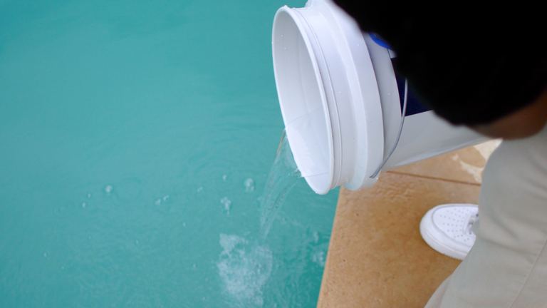 Pool Maintenance Bucket Nearly Empty Pouring Into Pool
