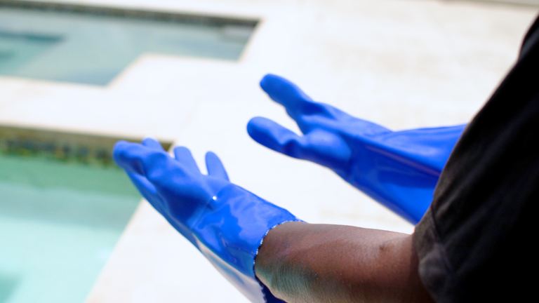 Wells Lamont PVC Gloves Both Hands Covered Held Out Poolside
