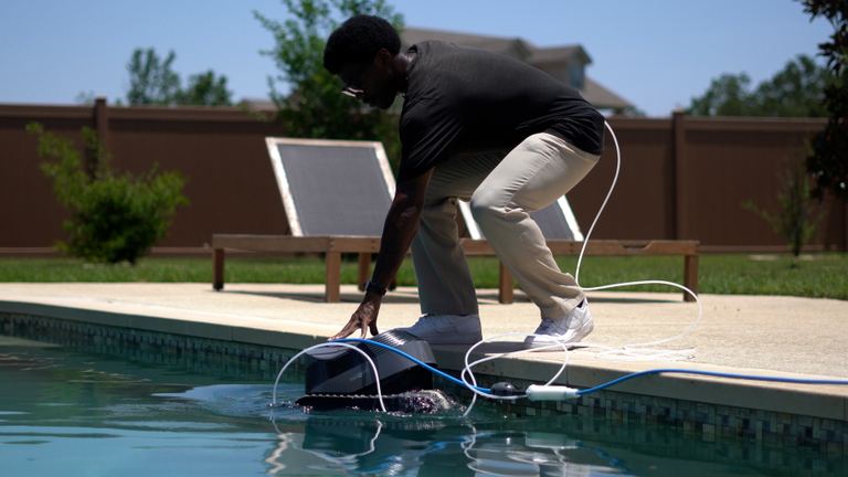 Dolphin Quantum Pro Lowering Into Pool At Edge